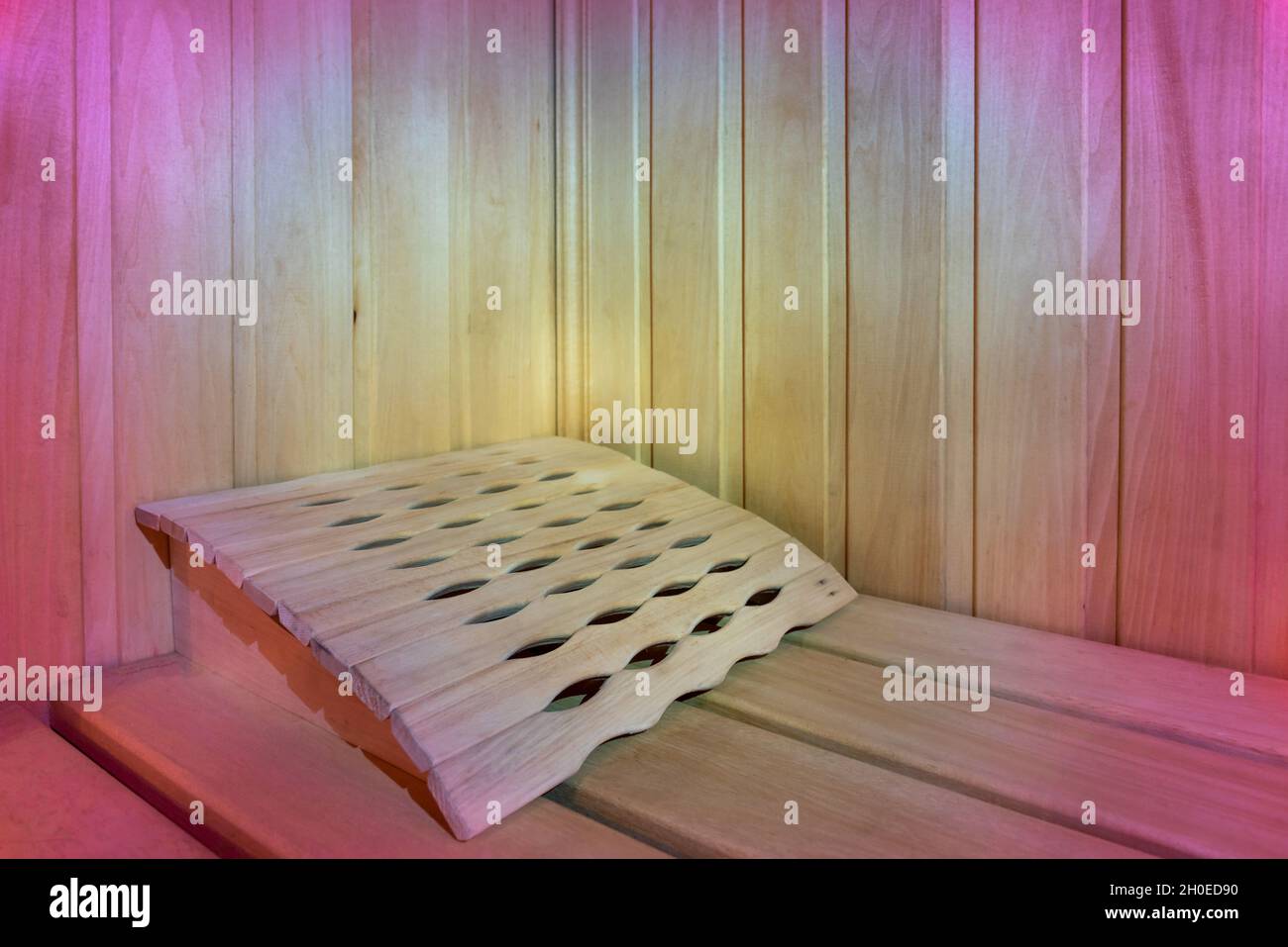Luminosa sala sauna in legno beige con luce rosa Foto Stock