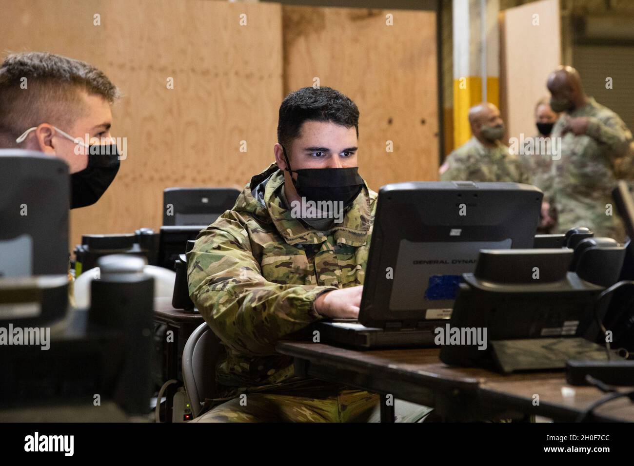 Soldati dell'esercito degli Stati Uniti assegnati al 2 ° Stryker Brigade Combat Team, 7 ° Divisione di fanteria, lavoro sul miglioramento dei sistemi di comunicazione e di rete come il generale maggiore Mitchell Kilgo (a destra), comandante generale, il comando delle comunicazioni dell'esercito degli Stati Uniti-elettronica è stato informato su North Fort Lewis, Washington, 22 febbraio 2021. La Brigata Lancer è la prima forza pronta per la regione Indo-Pacific e continua a mantenere la disponibilità in tutta la formazione. Foto Stock