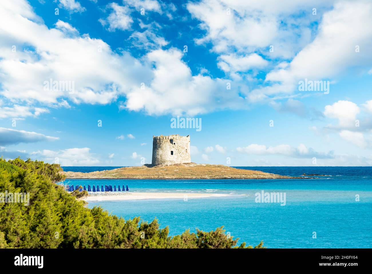 Paesaggio mozzafiato con la Torre Aragonese e la spiaggia di la Pelosa bagnata da una tranquilla acqua turchese. Spiaggia la Pelosa, Stintino, Sardegna nord-occidentale. Foto Stock