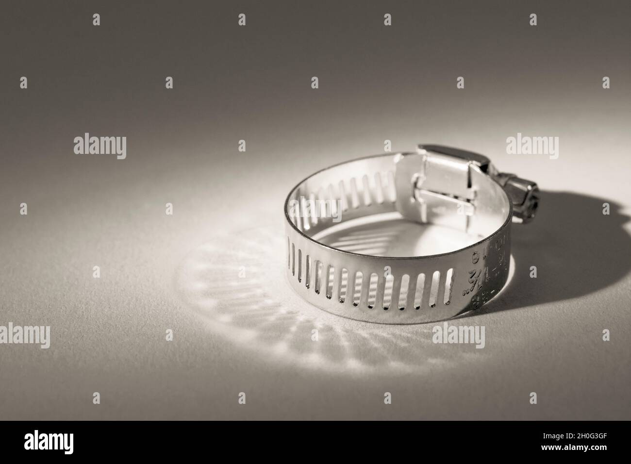 Primo piano astratto delle clip per tubo con attacco a vite senza fine Jubilee clip (queste non sono il vero marchio Jubilee). Per elementi di fissaggio fai da te, usi di metallo. Foto Stock