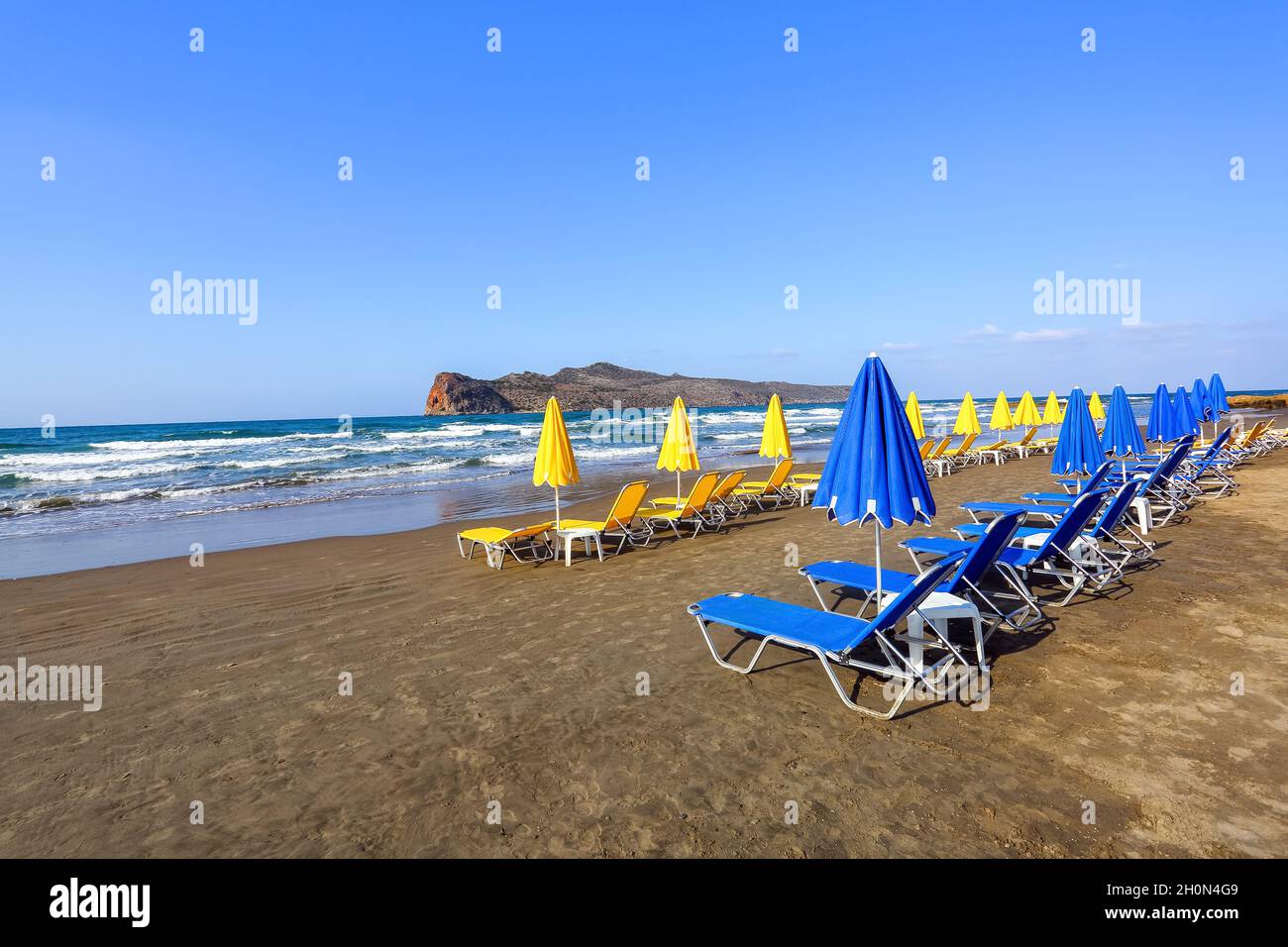 Spiaggia deserta con giallo, blu umbrellasand sdraio chiuso. Sabbia bianca e mare fantastici. Splendida vista sul mare durante l'estate. Relax luoghi isola Foto Stock