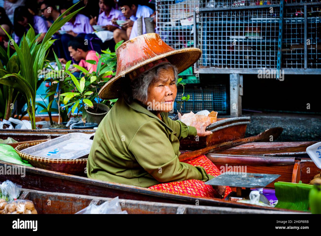 Un operatore di barca femminile che dà un giro a Damnoen Saduak; mercato galleggiante; Thailandia, 11/22/14 Foto Stock