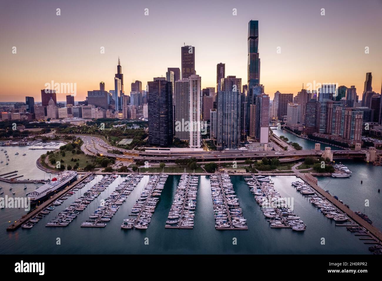 Vista aerea dello skyline della città e delle barche nel porticciolo al tramonto, Chicago, Illinois, USA Foto Stock