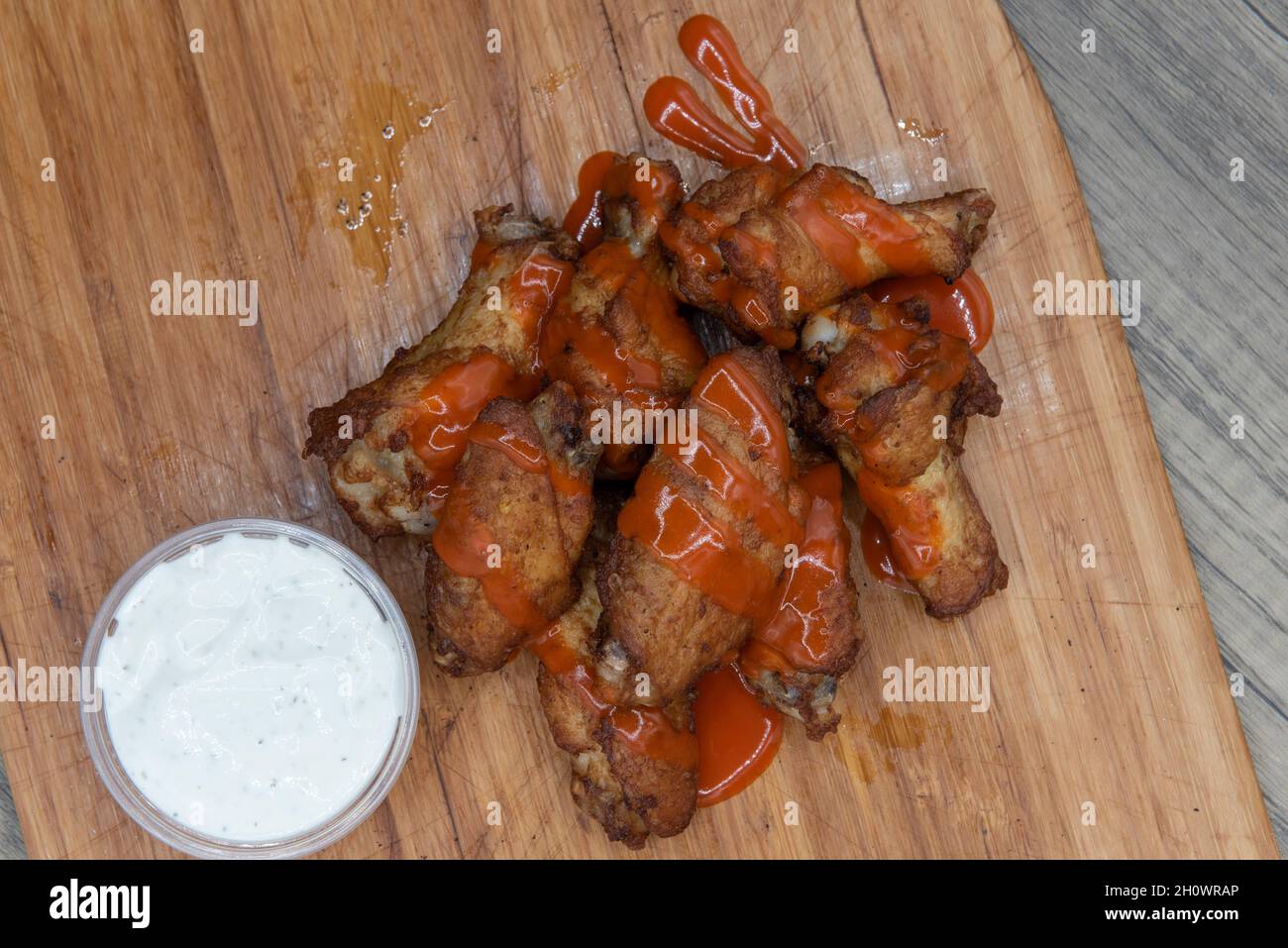 La vista dall'alto del piatto laterale delle ali di pollo alla bufala gocciolate è l'antipasto perfetto per un pasto abbondante da mangiare. Foto Stock