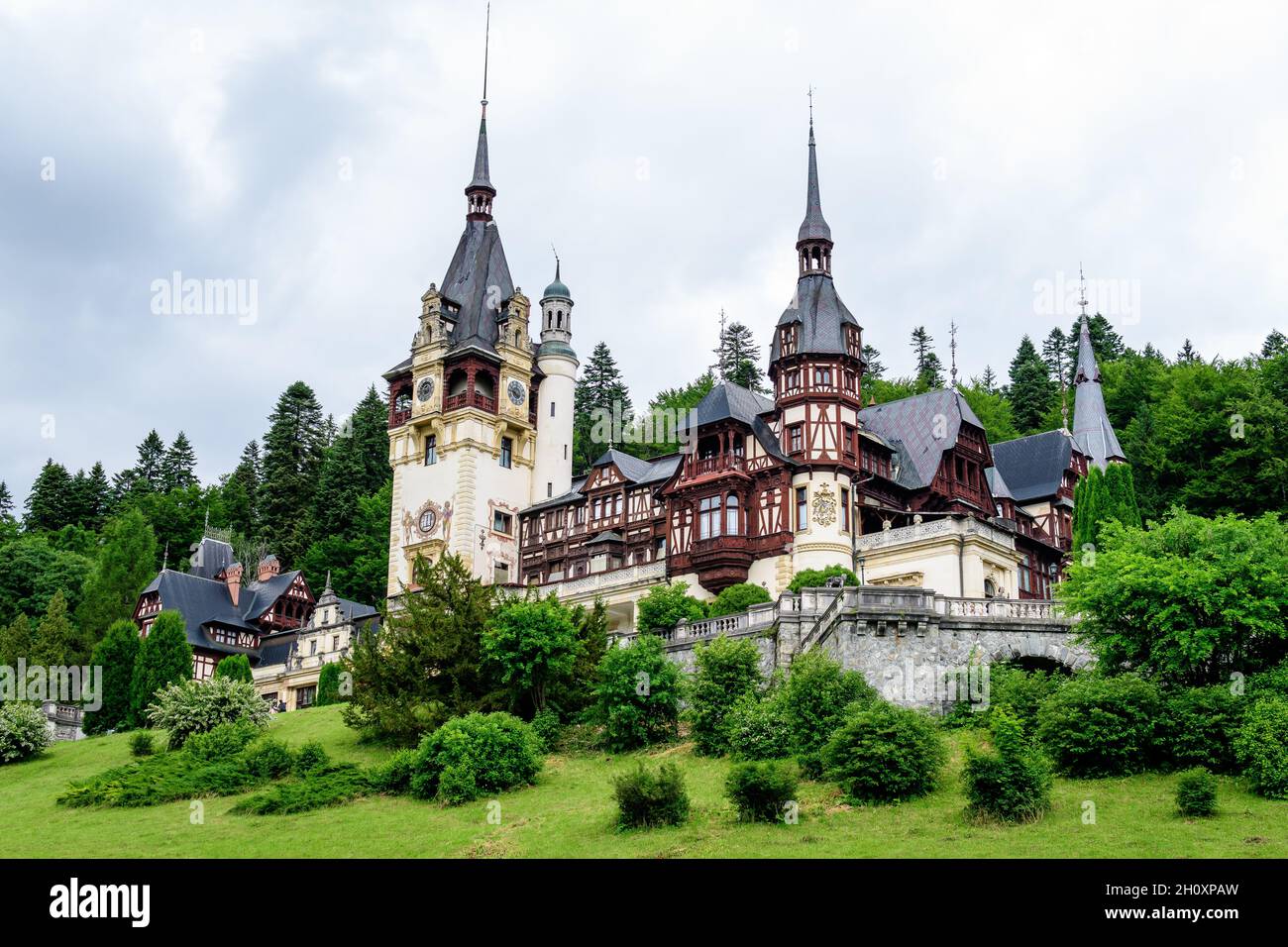 Bell'edificio neo-rinascimentale del Castello di Peles (Castelul Peles) vicino ai Monti Bucegi (Muntii Bucegi) in una nuvolosa giornata estiva nella città di Sinaia Foto Stock