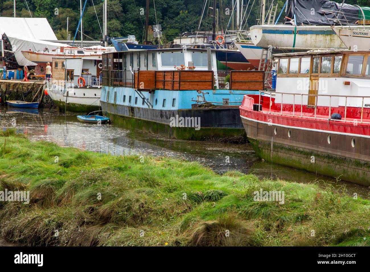 Barche ormeggiate nel cantiere a Gweek un villaggio sul fiume Helford vicino Helston nel sud della Cornovaglia Inghilterra Regno Unito Foto Stock