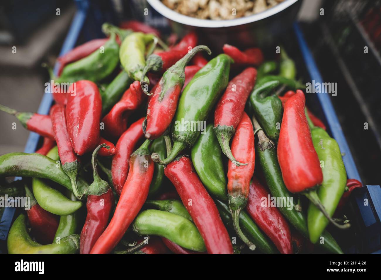 Profondità di campo poco profonda (fuoco selettivo) immagine con peperoni rossi e verdi caldi venduti da un uomo rumeno dal suo giardino in una zona rurale. Foto Stock