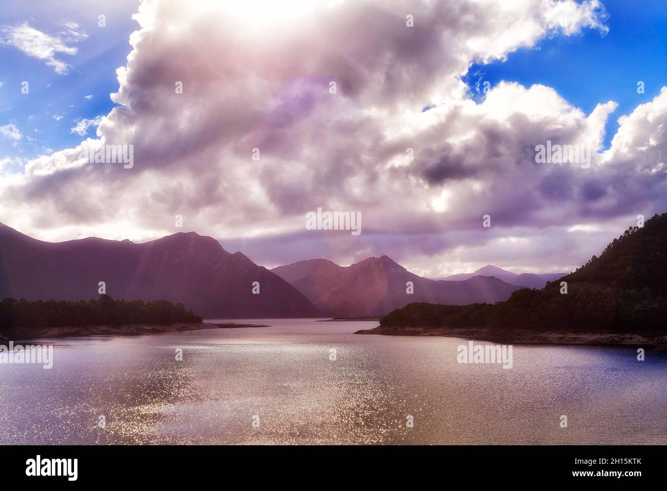 Drammatica formazione di nuvole di cielo sulle catene montuose sulle rive del lago di Bubury in Tasmania al largo dell'autostrada Lyell vicino a Queenstown. Foto Stock