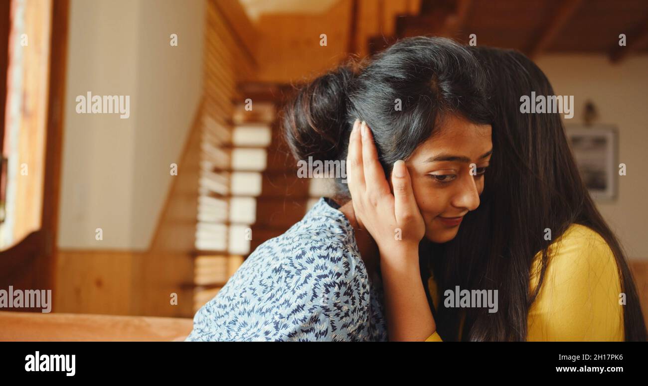 Una foto di due giovani amici sudasiatici in abbracci interni in India Foto Stock