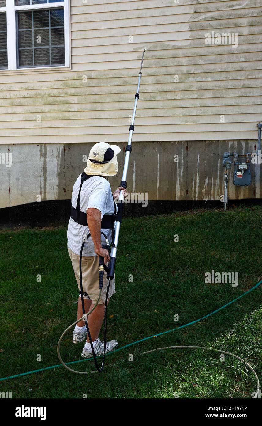 uomo potere lavando casa, bacchetta lunga, rimuovendo muffa, parte pulito, differenza, Raccordo beige, lavoro, manutenzione, MR Foto Stock