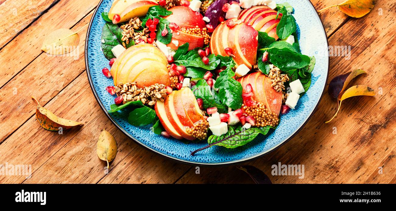 Insalata autunnale con mela, verde, farinata d'avena e formaggio. Cibo pulito su rustico tavolo di legno Foto Stock