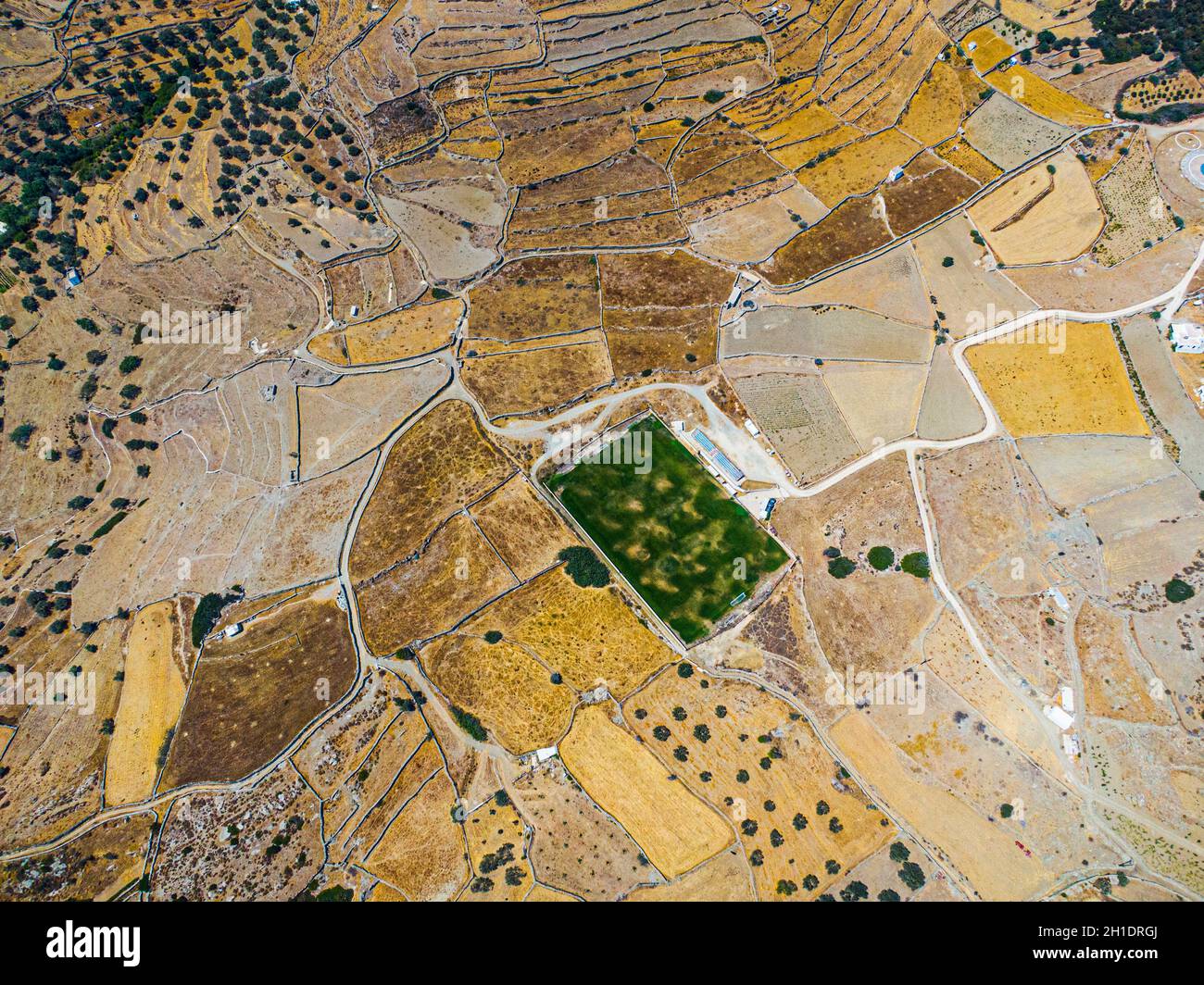Vista aerea su un campo di calcio verde durante la siccità sull'isola di sifnos, Grecia Foto Stock