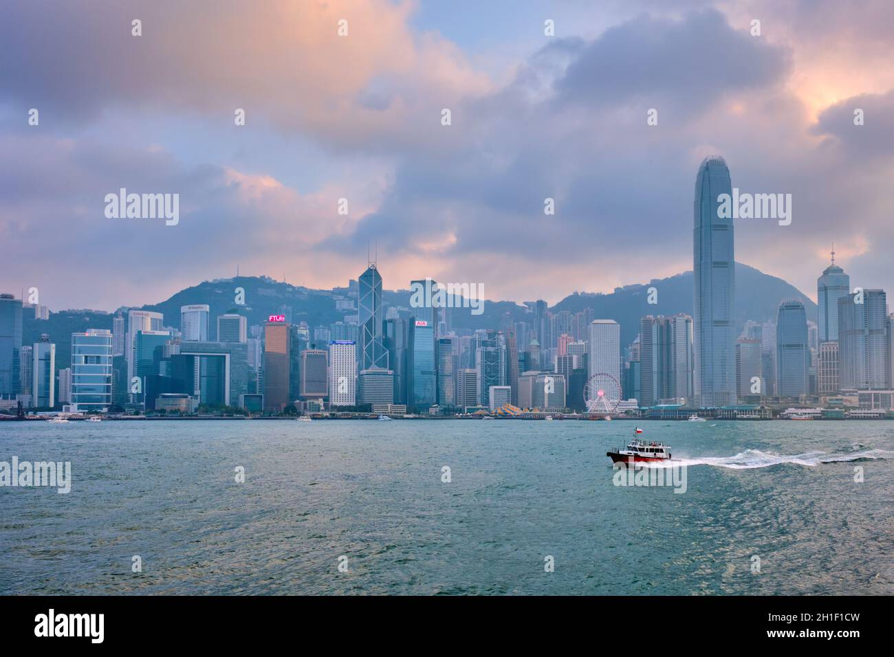 HONG KONG, CINA - 28 APRILE 2018: Skyline di Hong Kong skyline città grattacieli del centro di Victoria Harbour in serata al tramonto con spazzatura turistica b Foto Stock
