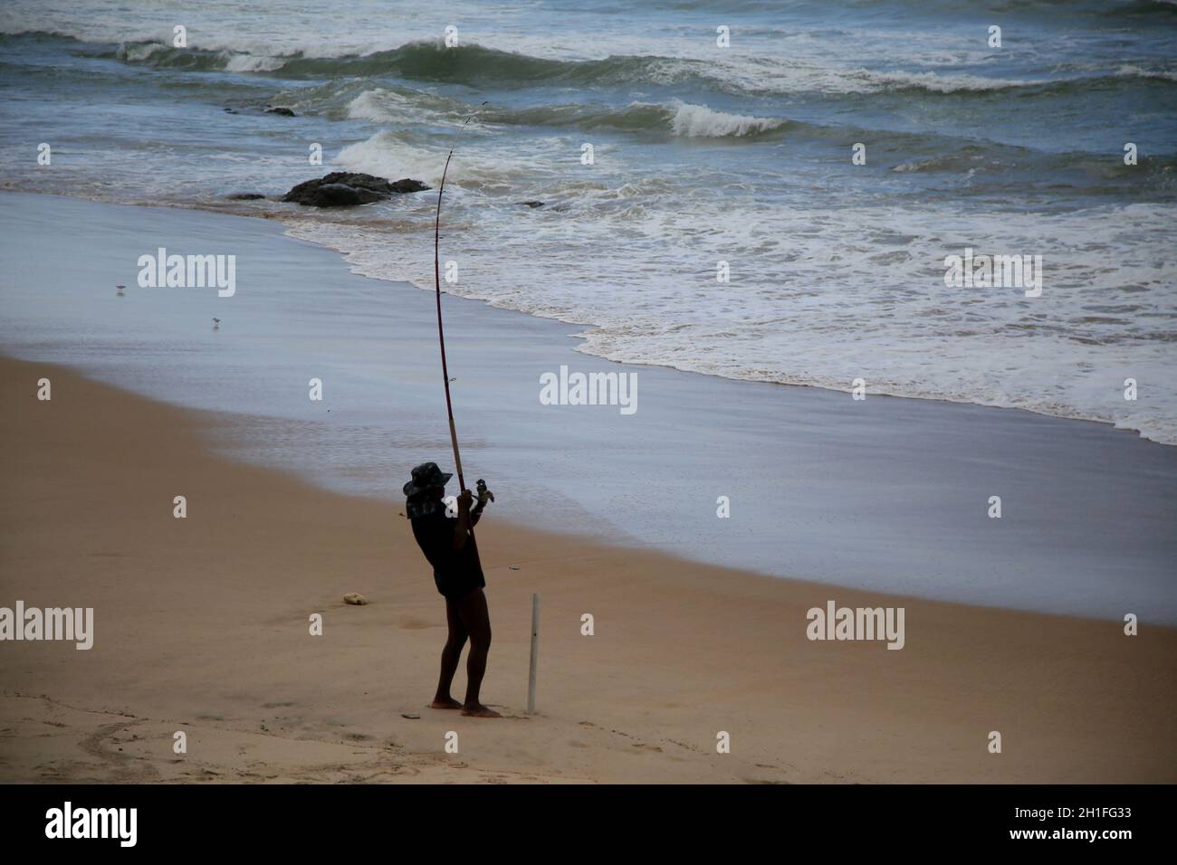 salvador, bahia / brasile - 5 novembre 2019: L'uomo è visto con la canna da pesca alla spiaggia di Pituba in Salvador. Il sito è stato influenzato dalla fuoriuscita di olio nel N Foto Stock