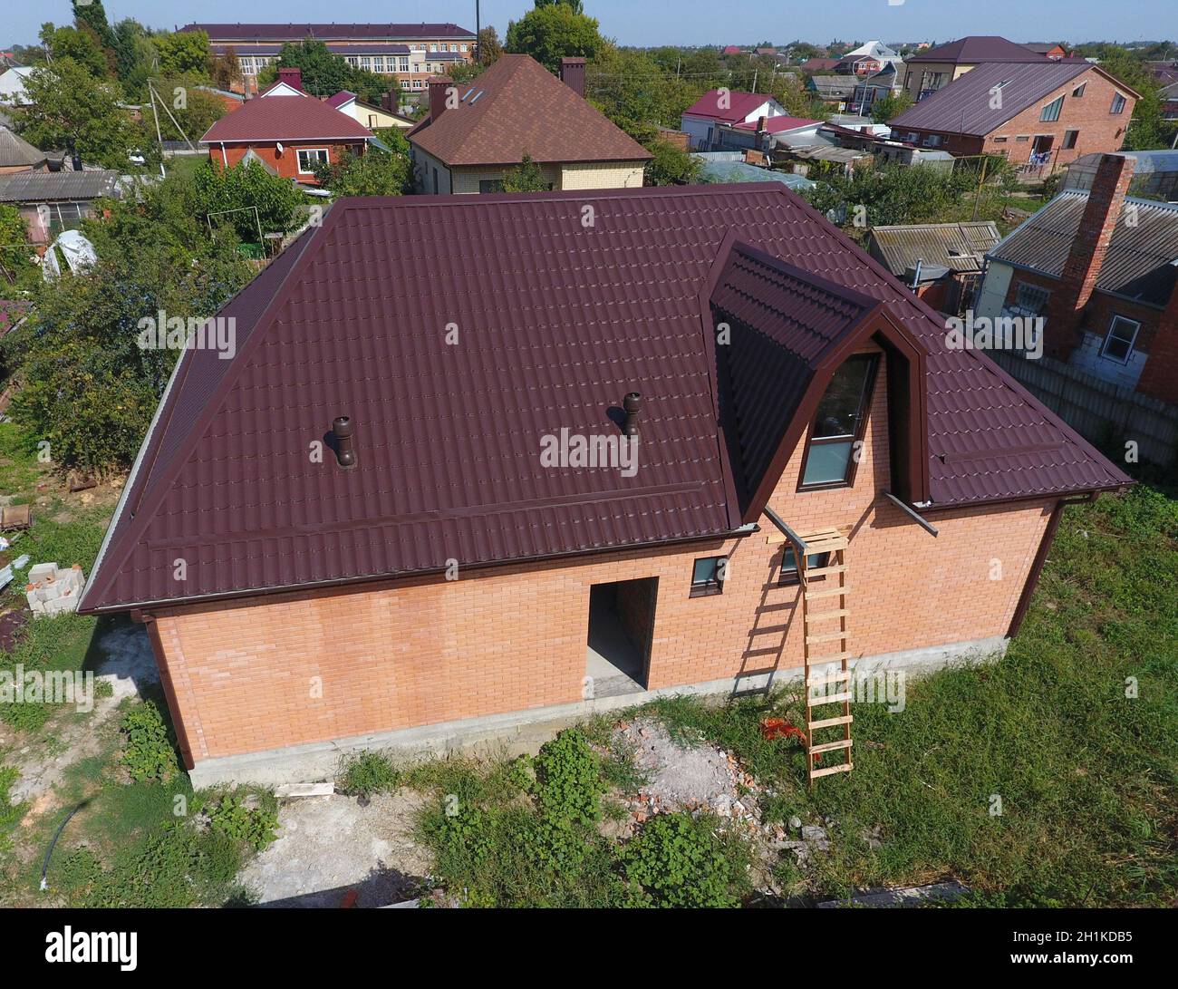 Il tetto del foglio ondulato. Copertura del profilo metallico di forma ondulata. Casa con un nuovo tetto di metallo. Foto Stock