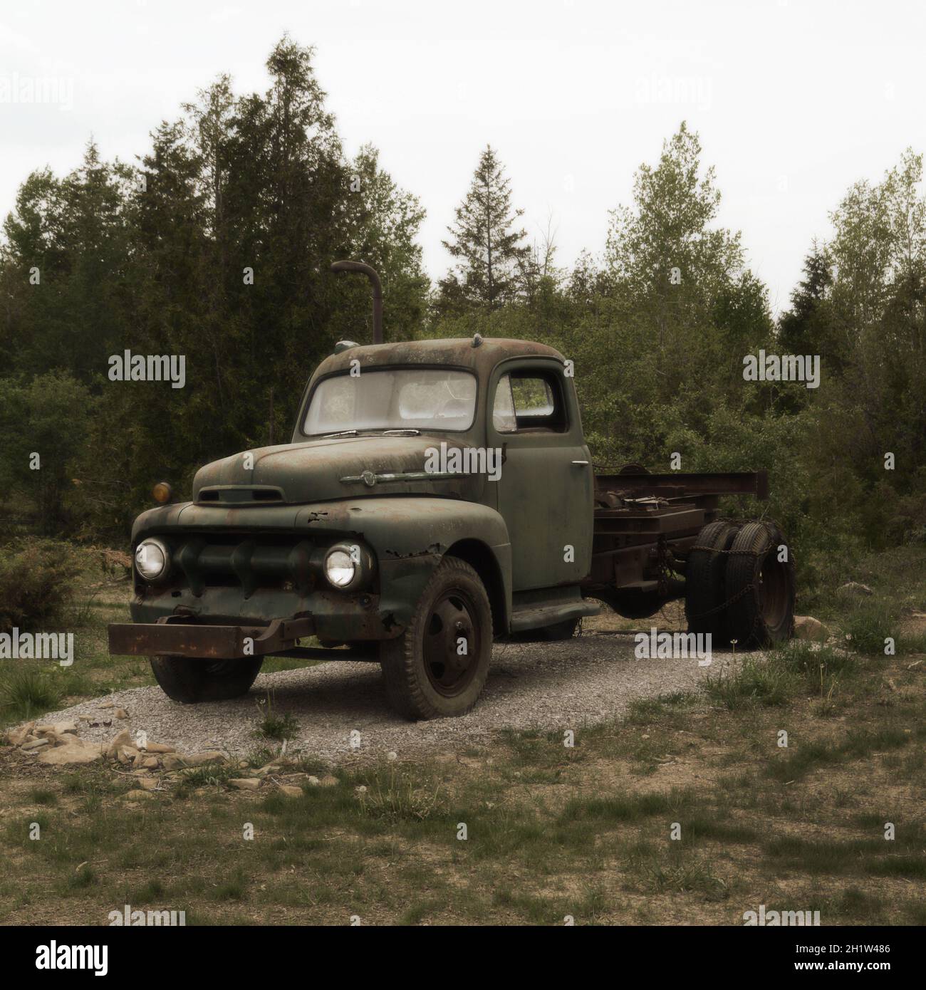 Una composizione vintage di un vecchio camion parcheggiato in un campo. Foto Stock