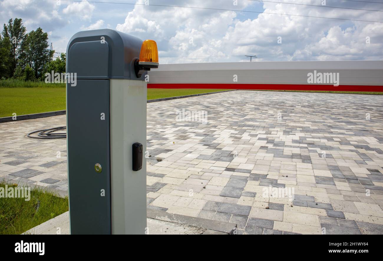 Chiudere il cancello. Sistema di sicurezza automatico. Sistema di accesso automatico. Segnale luminoso giallo con barriera stradale. Barriere di sicurezza sistema di sicurezza automatico Foto Stock