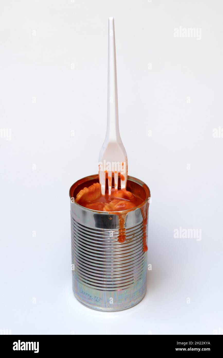 Ravioli in lattina e forchetta di plastica, pasto pronto con forchetta Foto Stock