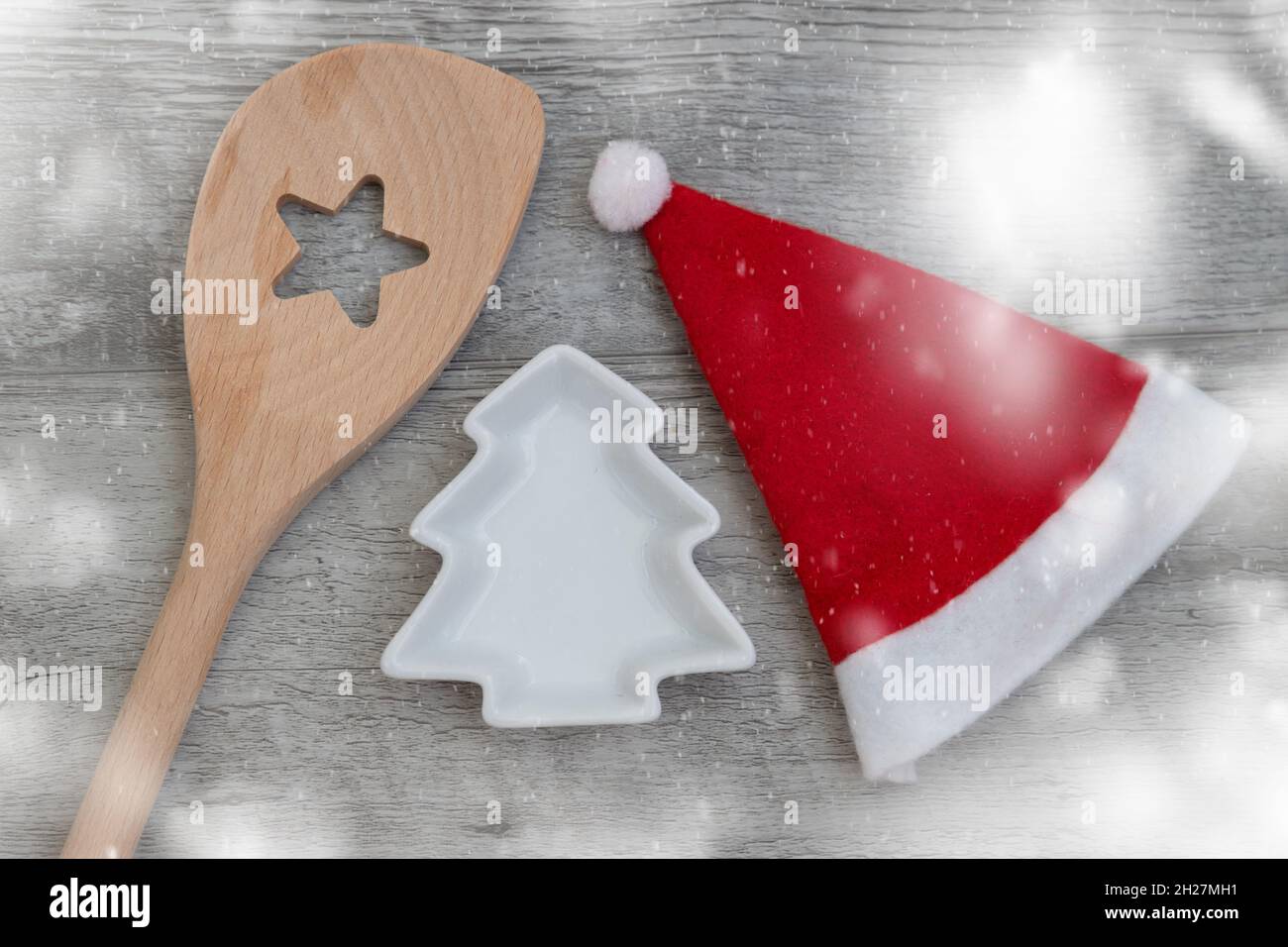 vista dall'alto del cucchiaio di natale in legno, ciotola a forma di albero di natale, e un cappello di natale, concetto per prepararsi per la cottura di natale Foto Stock