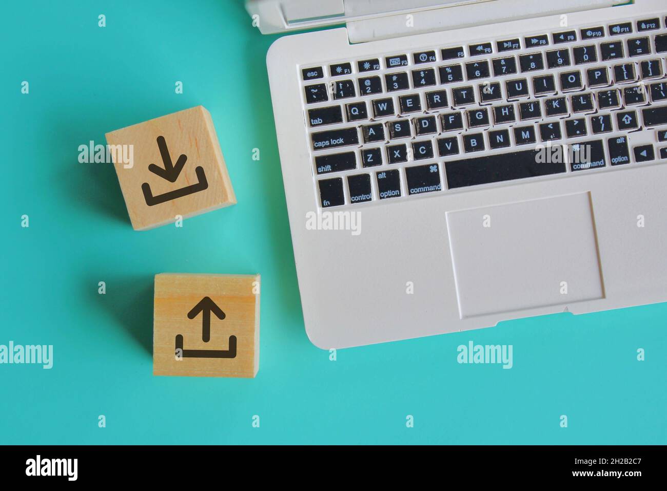 Internet e tecnologia. Vista dall'alto di notebook e blocchi di legno con logo icona di upload e download. Foto Stock