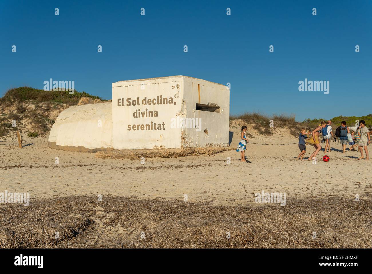 Es Trenc, Spagna; ottobre 11 2021: Vecchio bunker della guerra civile spagnola sulla spiaggia di es Trenc, vicino ai bagnanti, al tramonto. Isola di Maiorca, Spagna Foto Stock