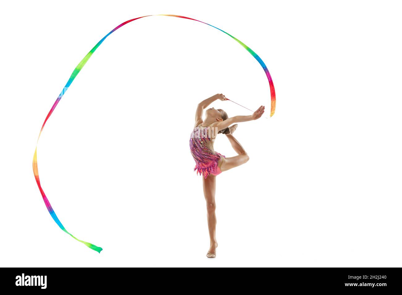 Ritratto a tutta lunghezza di bambina, allenamento professionale con  ginnastica ritmica, esecuzione con nastro colorato isolato su sfondo bianco  Foto stock - Alamy