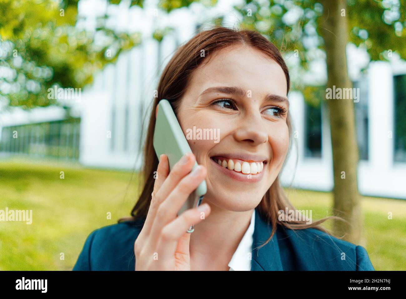 Sorridente professionista che invia messaggi vocali tramite smartphone Foto Stock
