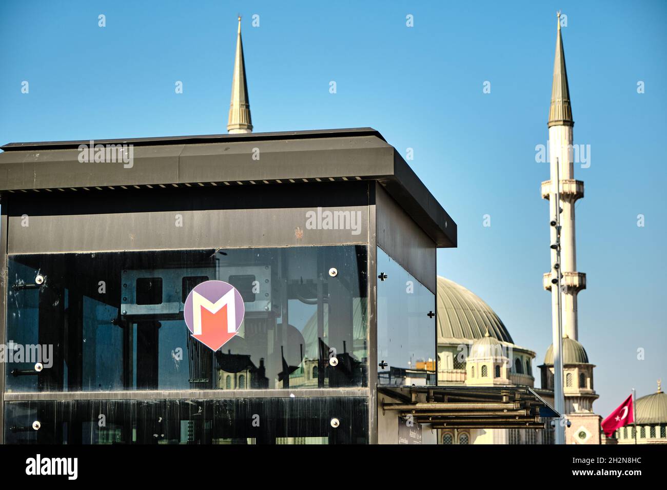 stazione della metropolitana di istanbul (Marmaray) in Piazza Taksim e cartello con la moschea di taksim e il suo sfondo minareto durante la giornata di sole Foto Stock