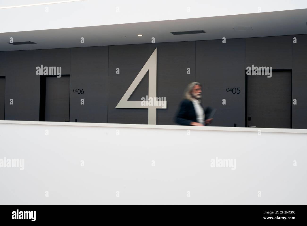 Uomo d'affari maturo che corre nel corridoio dell'hotel Foto Stock