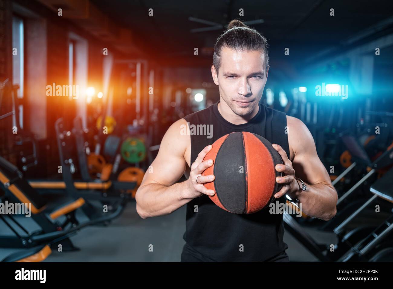 il giovane atleta maschio con basket o palla medica si allena in palestra Foto Stock
