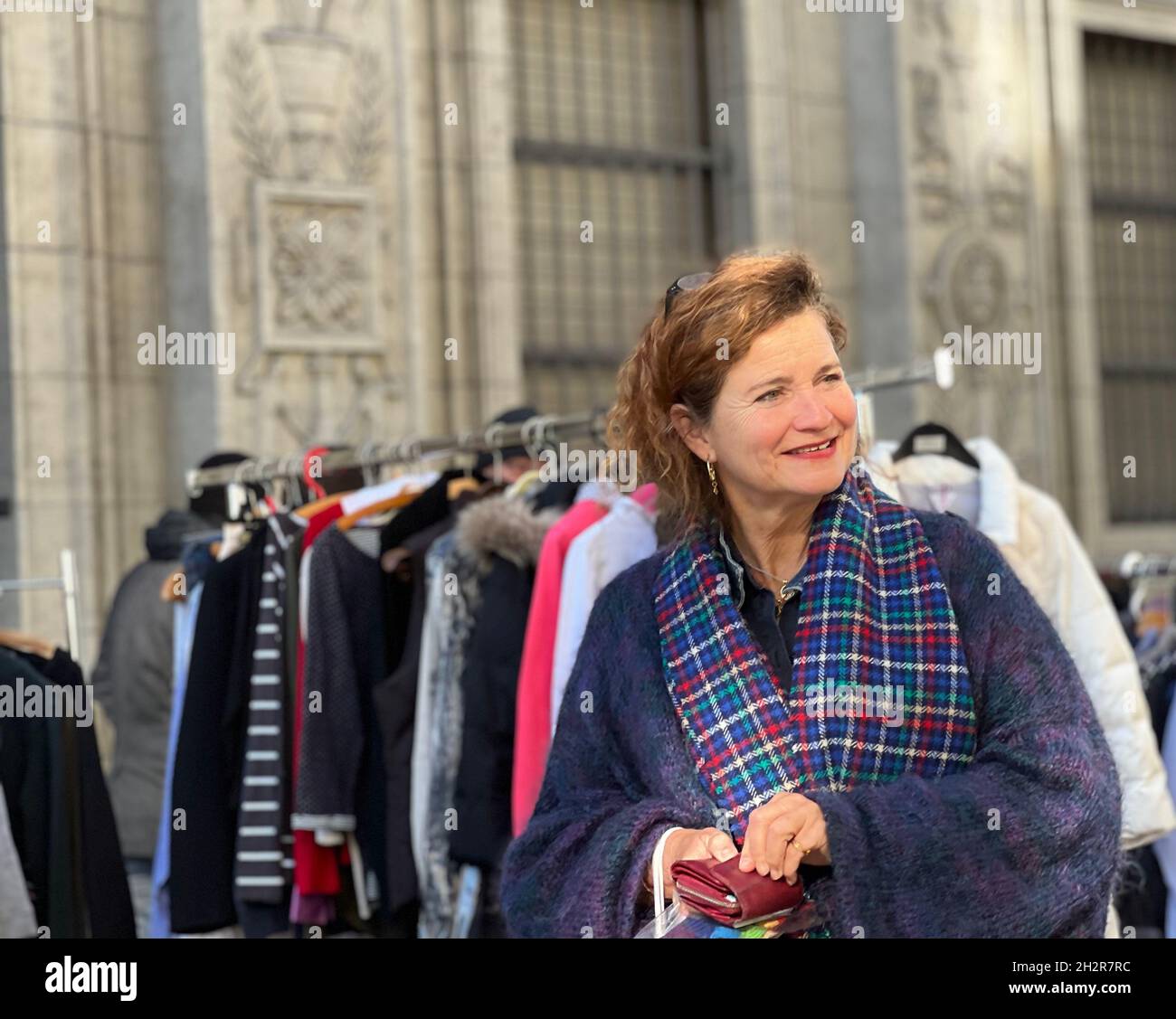 Donna di mezza età al mercato delle pulci di Zurigo. Lei tiene la sua borsa ed è sorridente, felice di shopping e affari al mercato. B Foto Stock