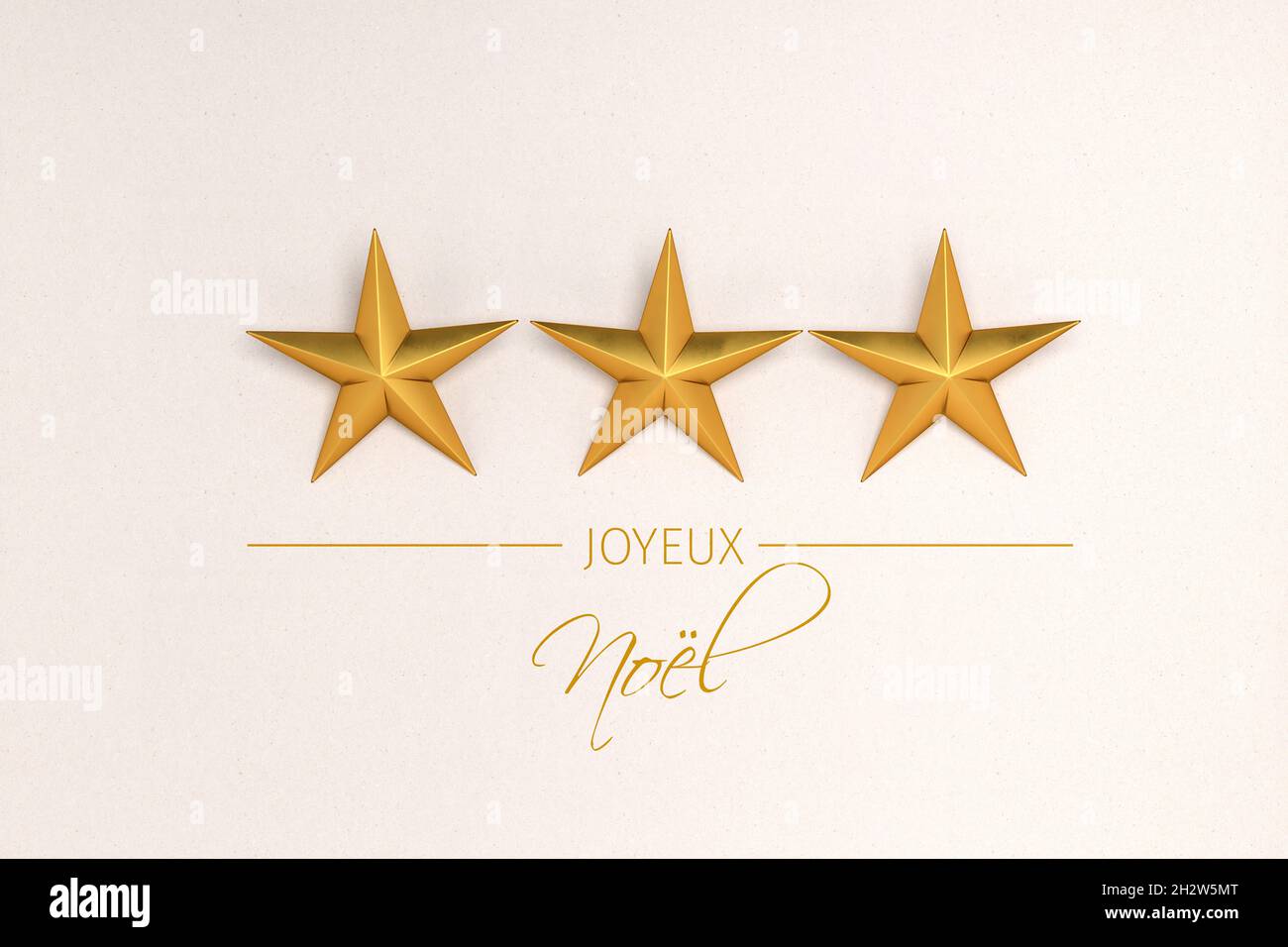 Tre stelle dorate di natale su sfondo cartaceo. Messaggio francese "Joyeux Noël" (buon Natale) qui sotto. Foto Stock