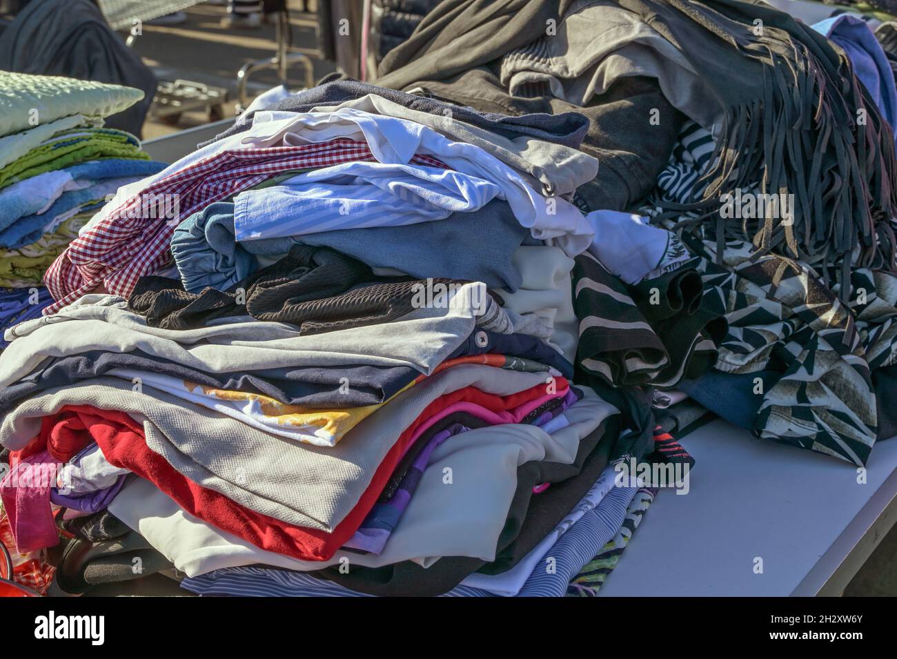 Mucchio di vestiti usati come donazione ad una carità o per la vendita del mercato delle pulci, fuoco selezionato, profondità stretta di campo Foto Stock