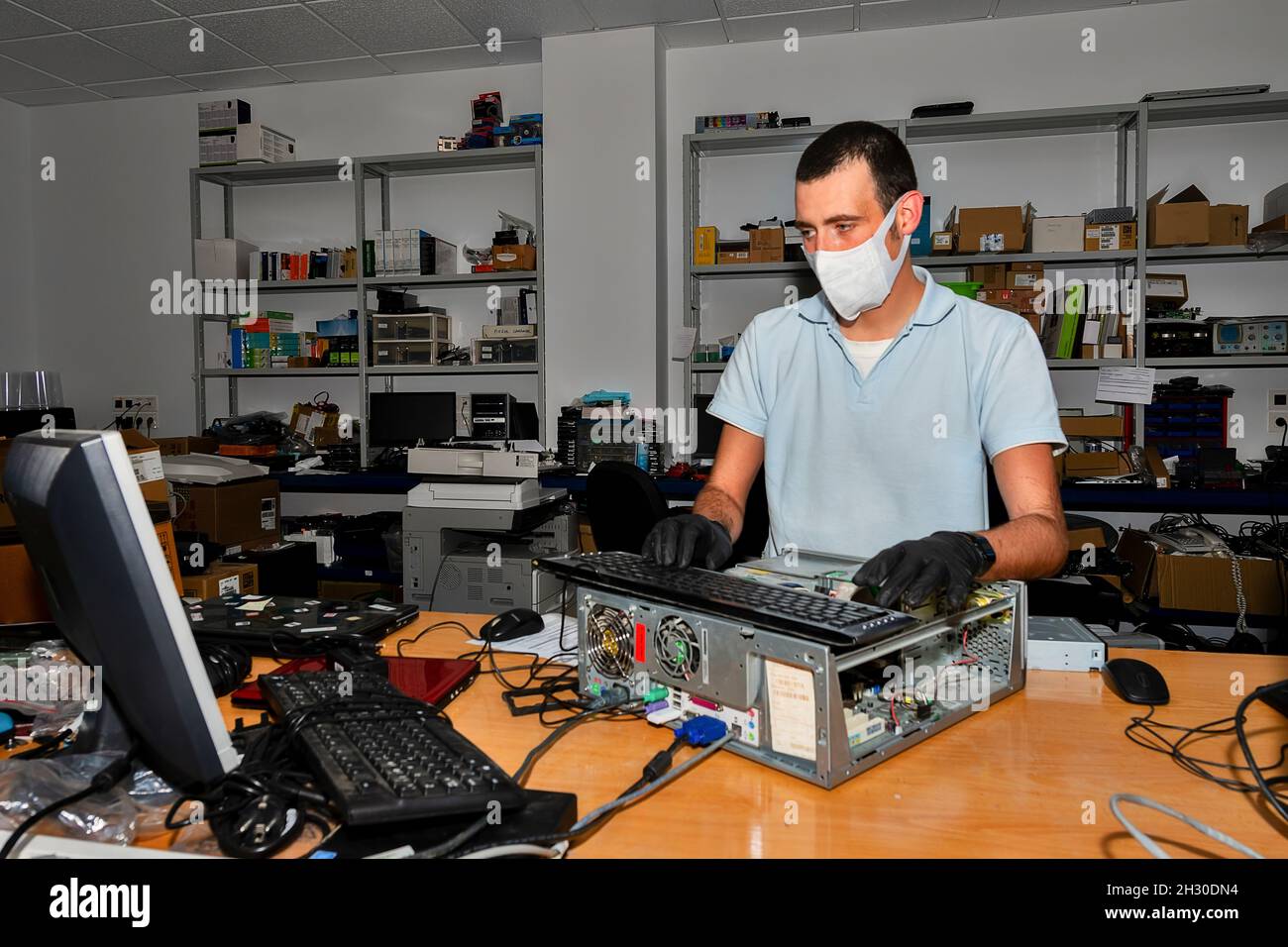 Tecnico informatico che lavora in officina Foto Stock