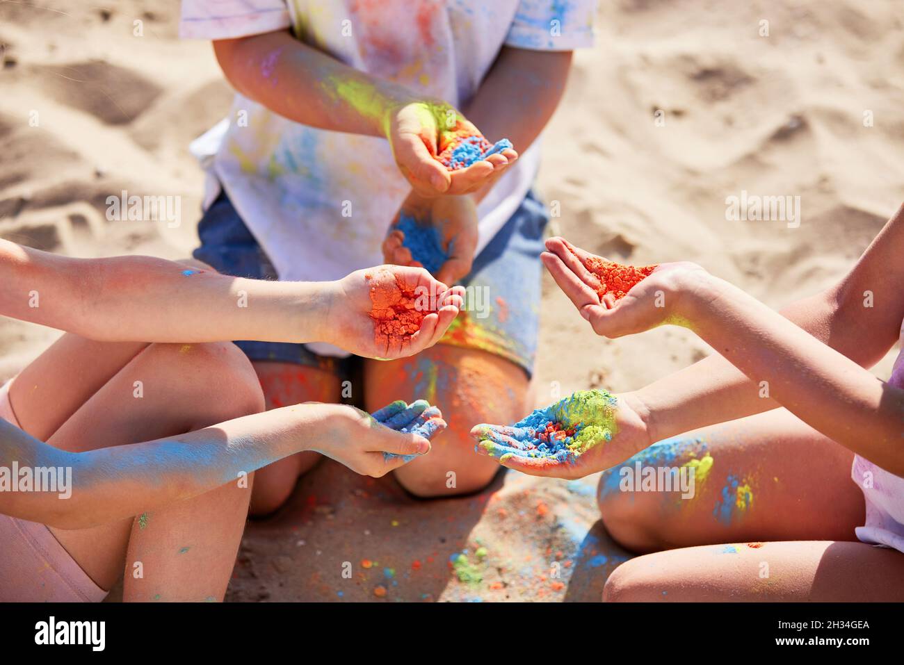 tre bambini che tengono in mano la polvere colorata Foto Stock