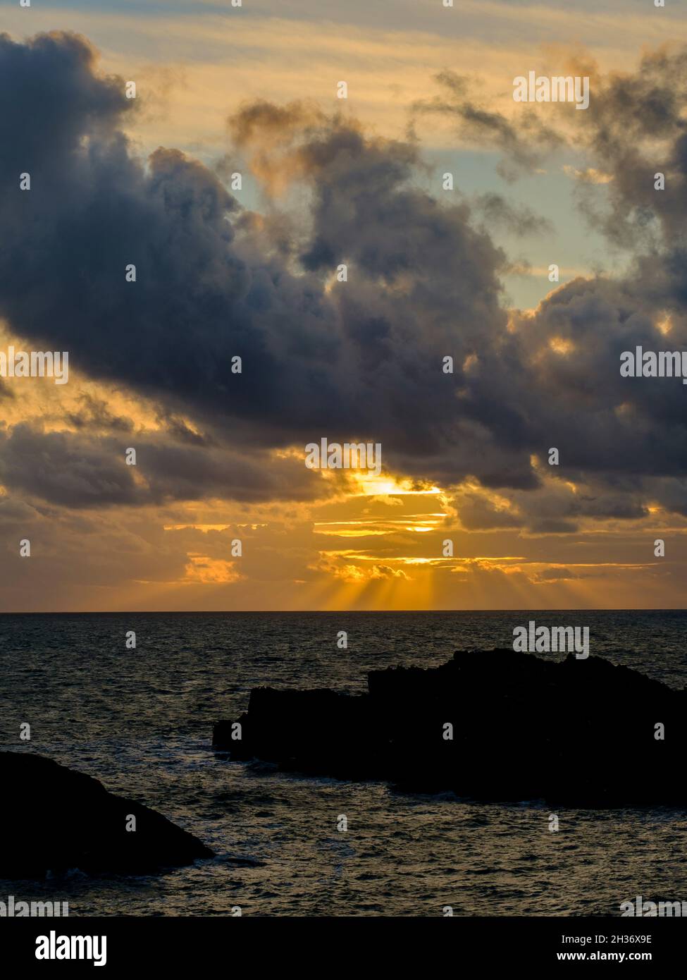 Un tramonto drammatico al largo della costa su Ynys Llandwyn su Anglesey, Galles del Nord, Regno Unito Foto Stock