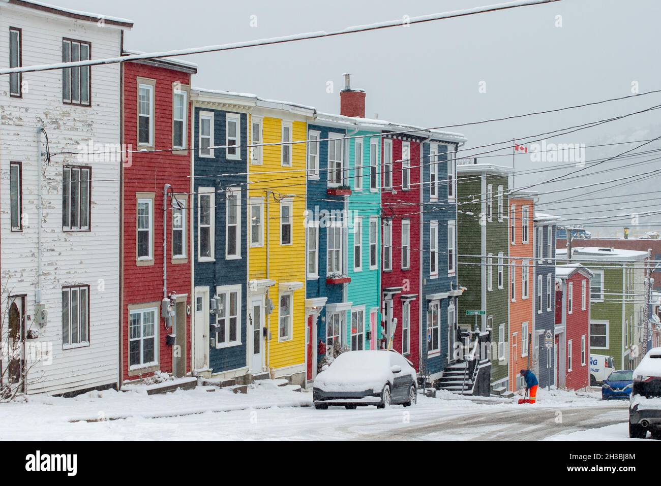 St. John's, NL, Canada-Ottobre 2021: Case a schiera in legno colorate, su una strada con una leggera collina. Ci sono dormitori e tetti alla moda. Foto Stock