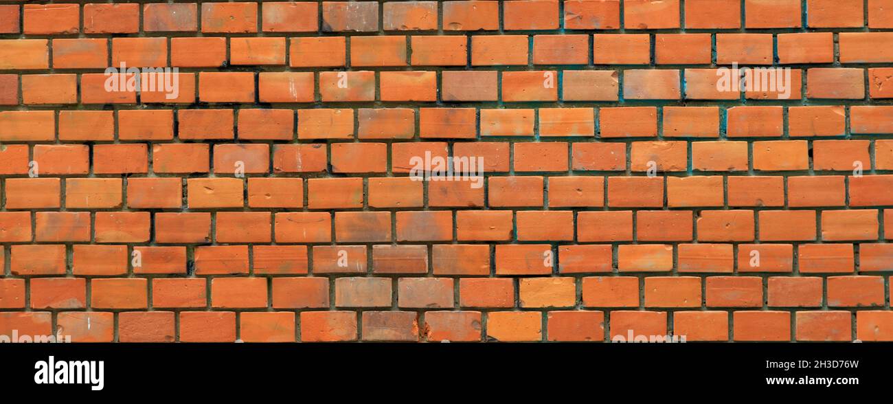 Sfondo di texture muro di mattoni rossi. Facciata tradizionale dell'edificio Foto Stock