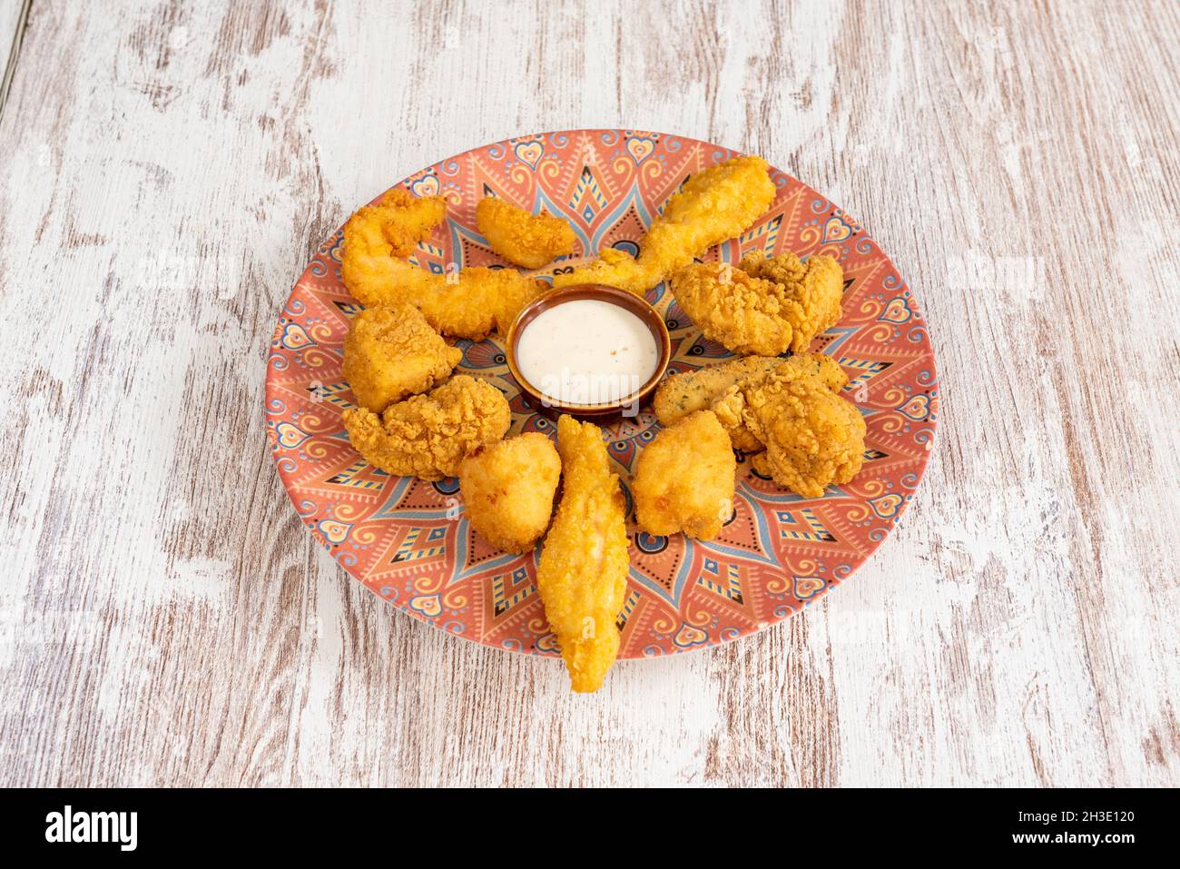 Assortimento di pezzi di pollo ricoperti di farina, pangrattato, uova e salsa al formaggio per l'immersione Foto Stock