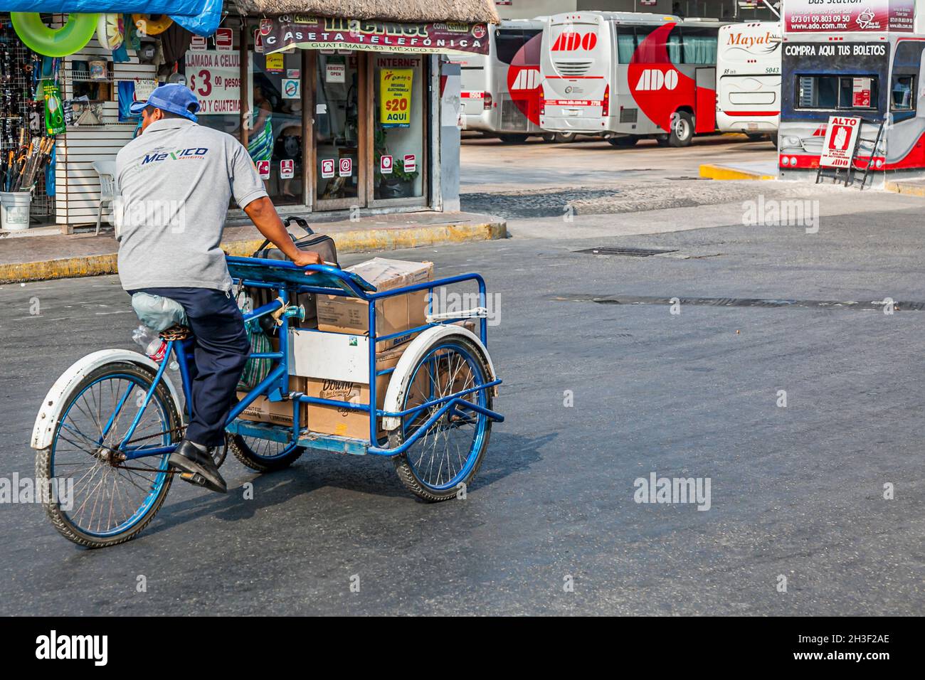 Messico, maggio 2011 - venditore di strada o uomo di consegna a cavallo di un triciclo con merci in un quartiere di Playa del Carmen, Messico Foto Stock