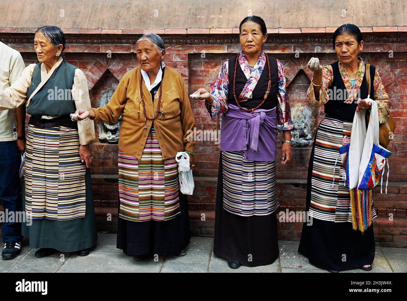 Nepal. Valle di Kathmandu. Swayambunath stupa. Donna tibetana che offre farina per Losar, il nuovo anno tibetano. Foto Stock
