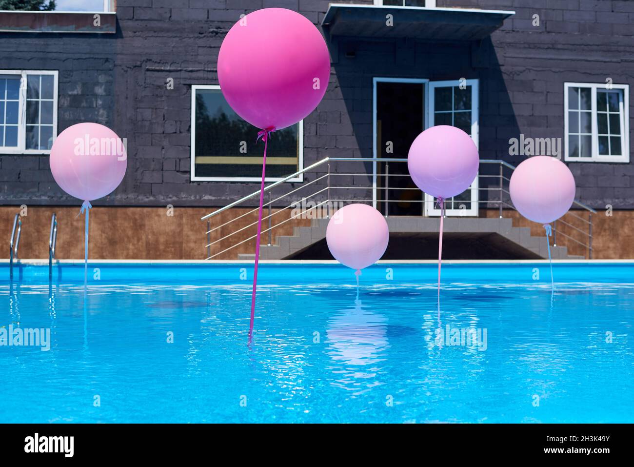 Piscina con palloncini colorati sullo sfondo della nuova costruzione casa  Foto stock - Alamy