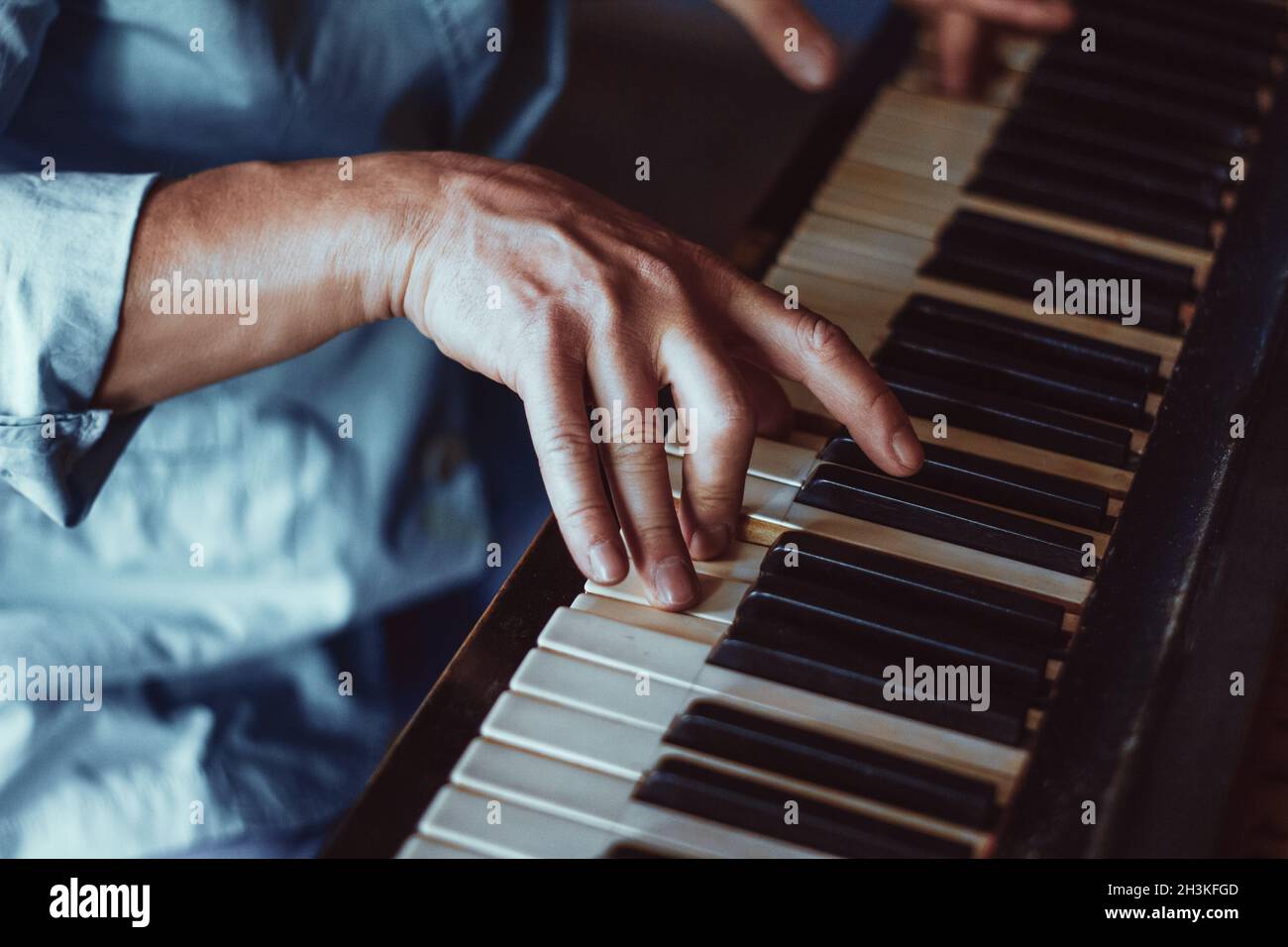 Maschio a mano della riproduzione di un pianoforte. Close-up. Musica Foto Stock