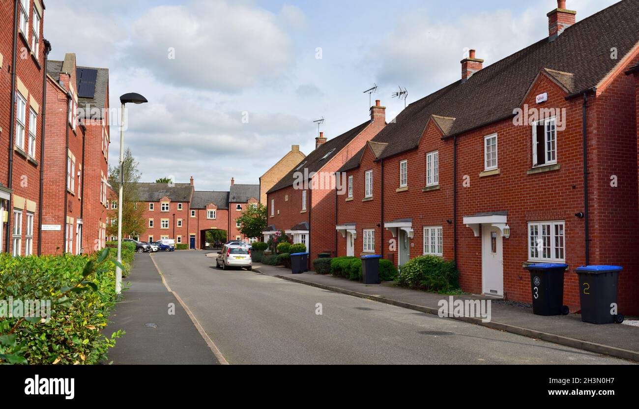 Strada di mattoni britannici moderno costruito case su piccola proprietà privata, Henley-in-Arden, Regno Unito Foto Stock