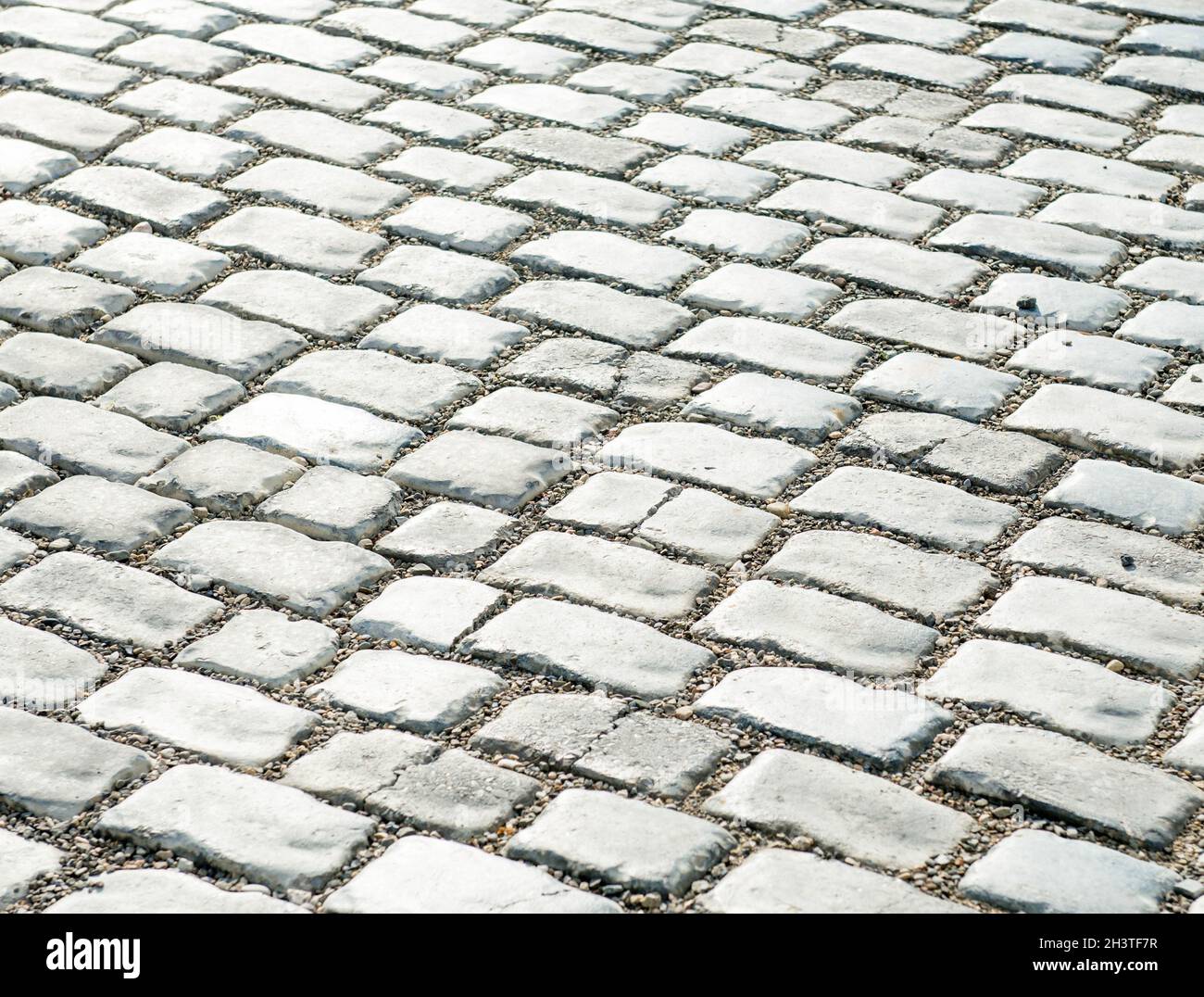 Strada pavimentata con ciottoli per il tuo sfondo Foto Stock