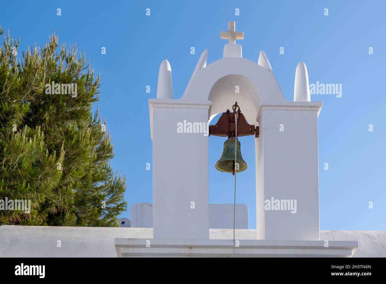 Grecia, Cicladi. Isola FOLEGANDROS, campanile della chiesa vecchia nella città di Chora. Tradizionale cappella delle Cicladi, pareti dipinte di bianco, cielo blu chiaro sfondo. Foto Stock