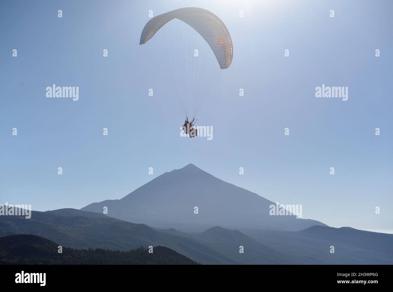 Parapendio volare nel cielo blu con il Monte Teide sullo sfondo. Tenerife, Isole Canarie, Spagna. Foto Stock