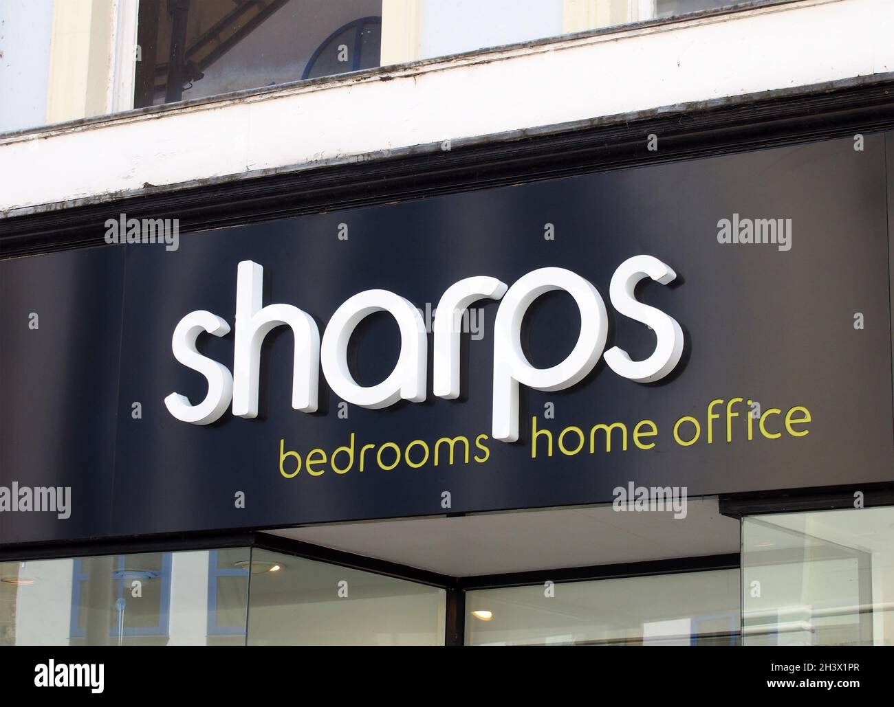 Insegna e logo sopra l'entrata di uno showroom di mobili in stile sharps sulla strada commerciale nel centro di leeds Foto Stock