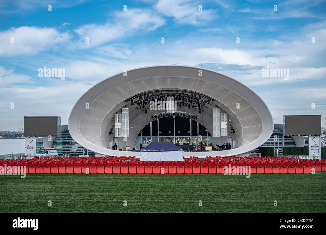 San Diego, California, Stati Uniti d'America - 4 ottobre 2021: La sala concerti White Rady Shell al Jacobs Park. Vista frontale in esso con file di sedie rosse su verde Foto Stock