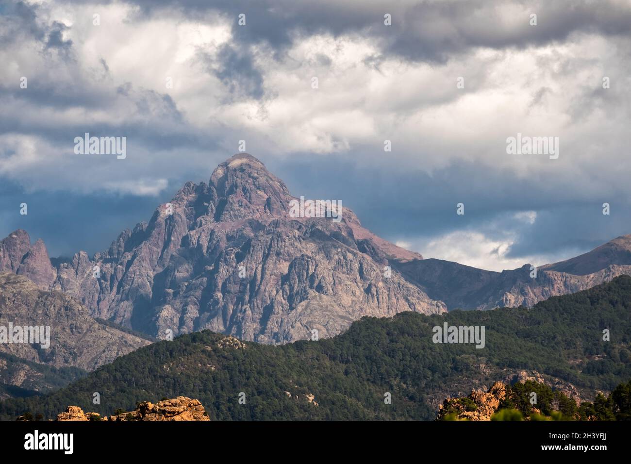 La vetta rocciosa della paglia Orba nella Corsica centrale sotto cieli bui e tempestosi Foto Stock